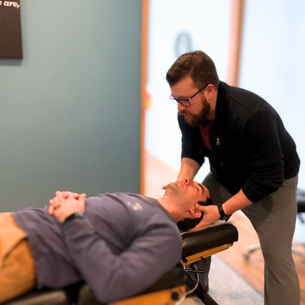 Dr. Nathan analyzing the upper cervical region using the MC2 chiropractic technique, in Palatine, IL.